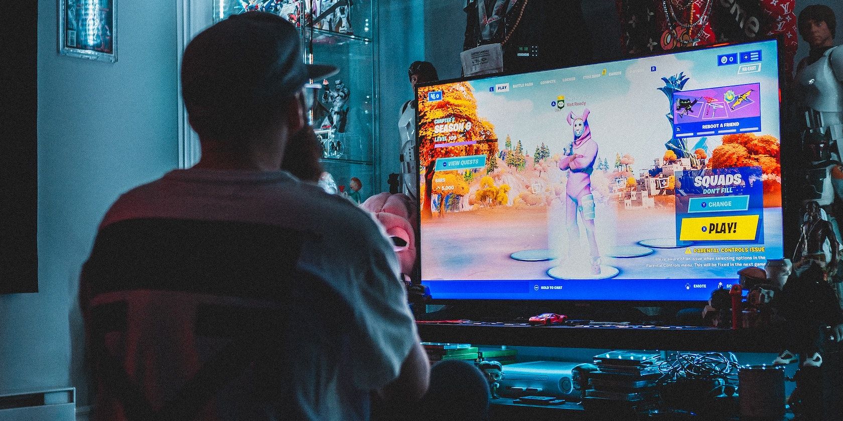 A person wearing a cap and playing Fortnite
