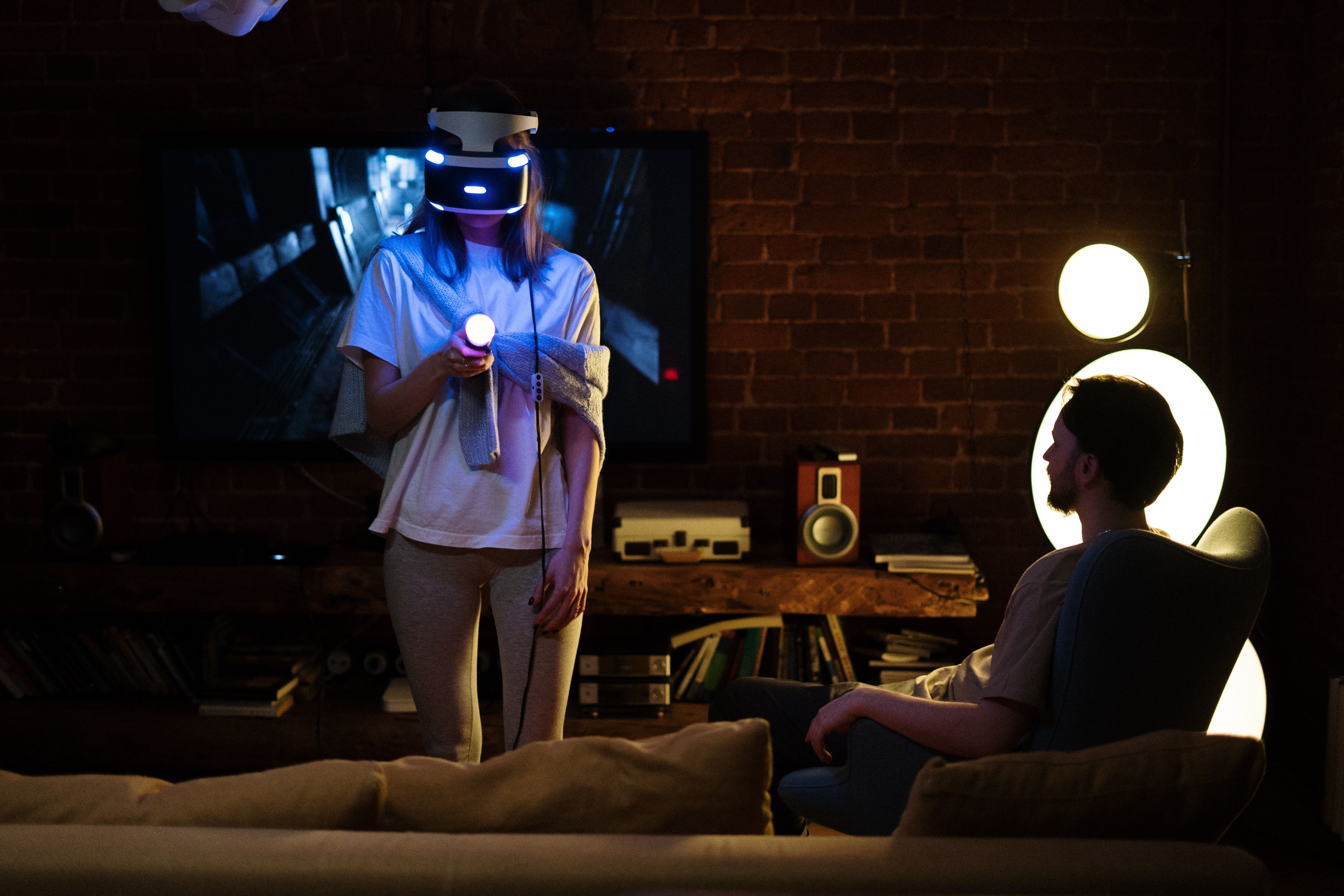 Woman using VR headset in living room with her partner