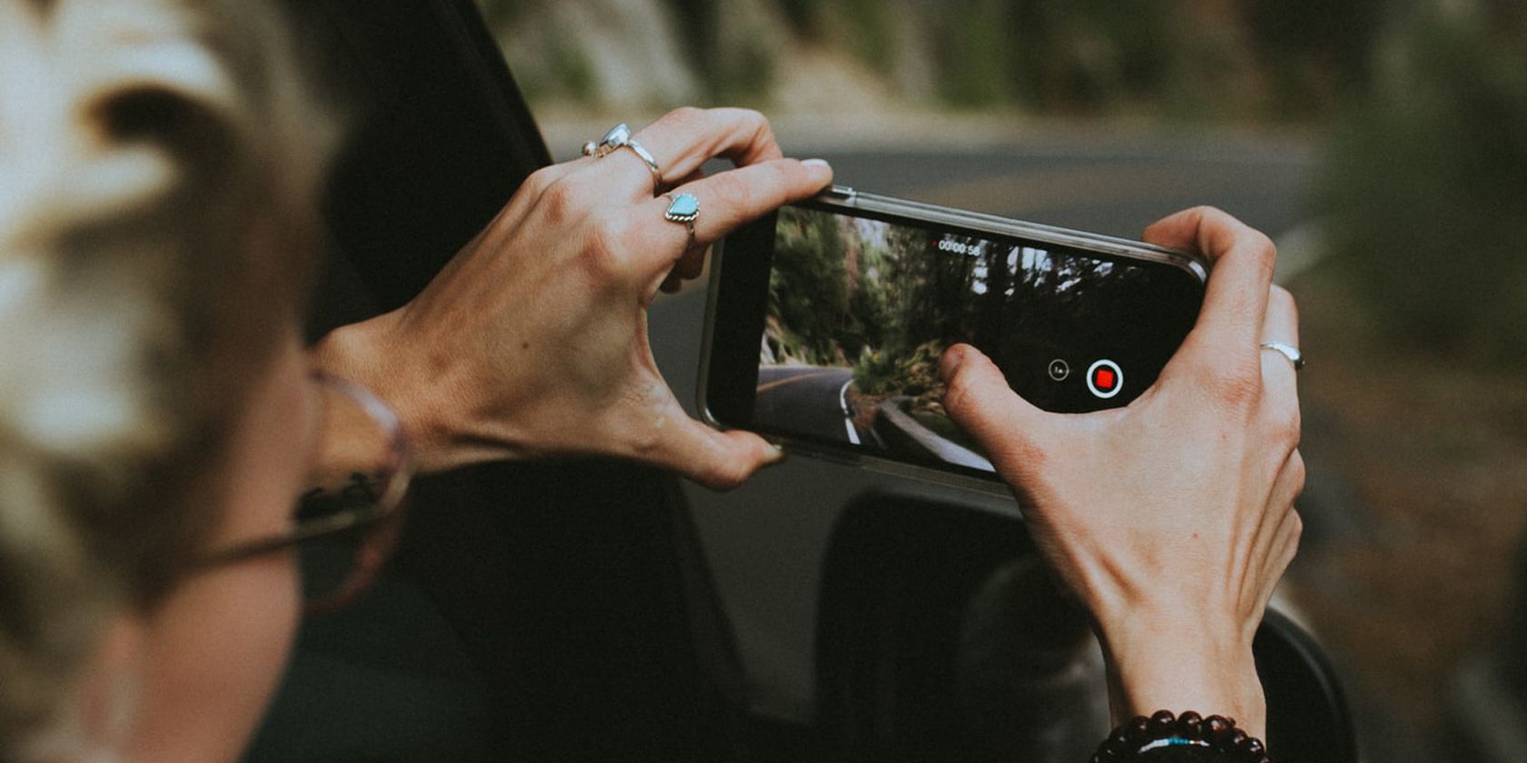 person taking videos on their smartphone