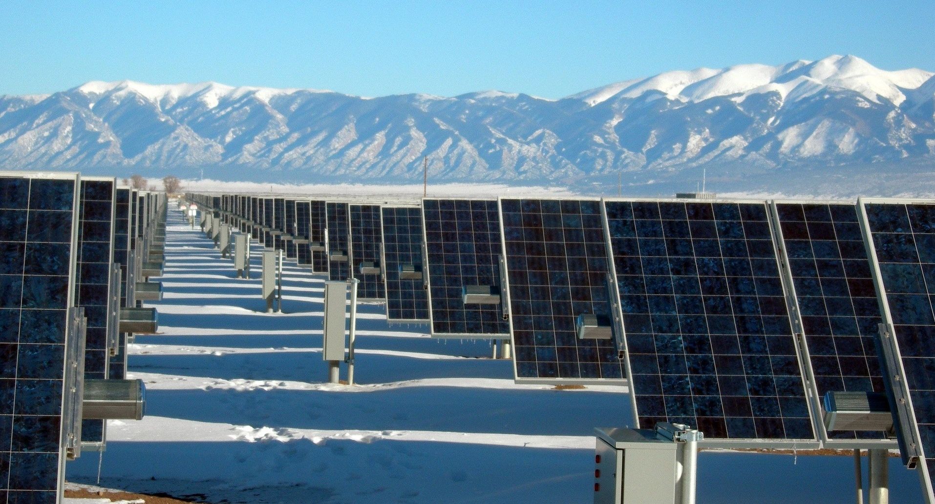 solar panels in front of mountains