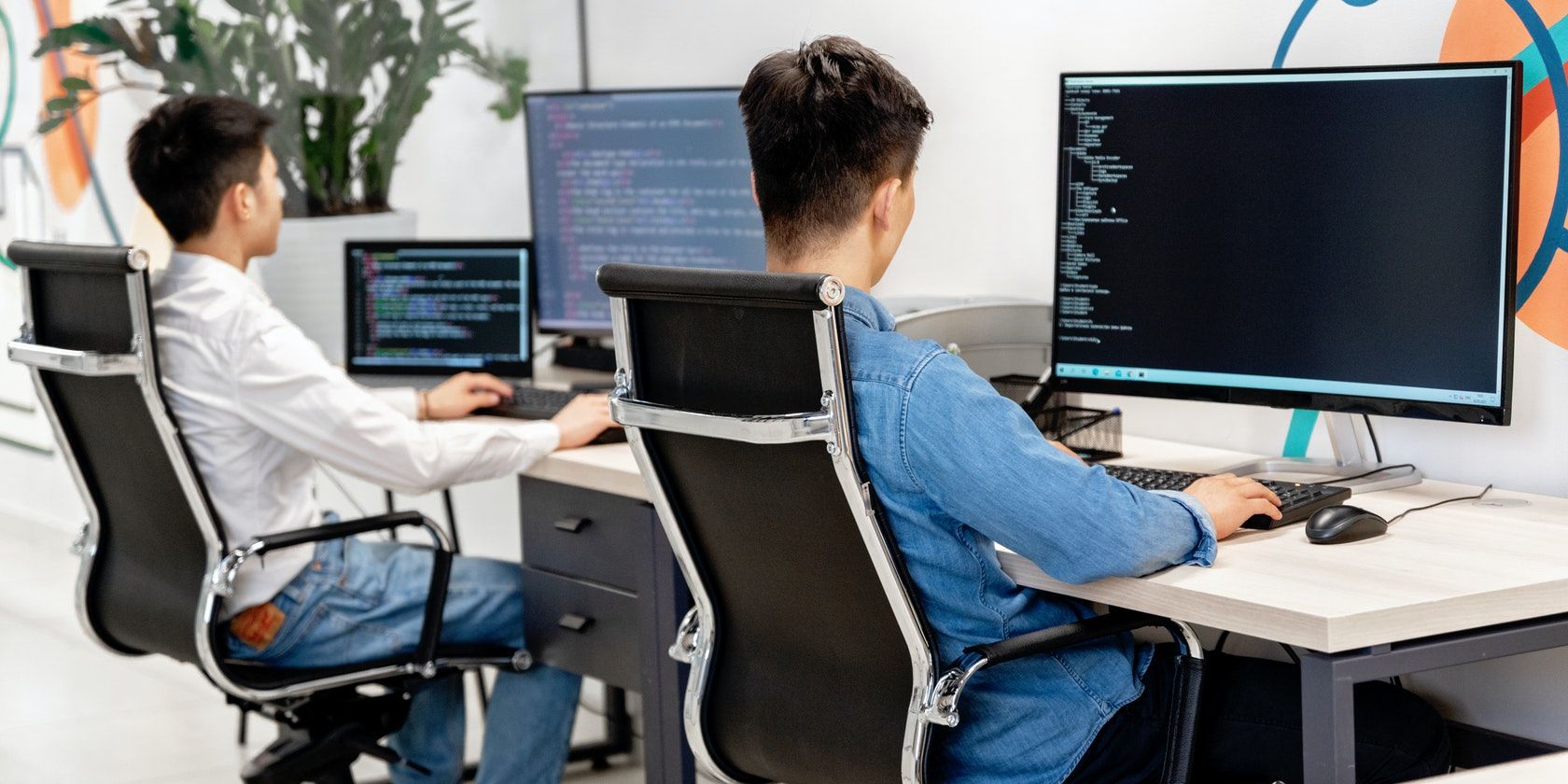 Two men working on their computers