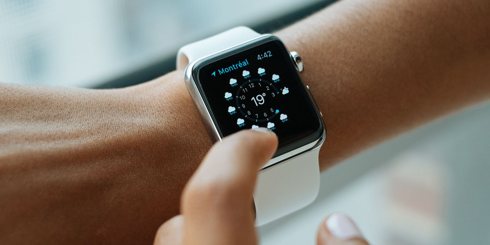 Photo of a person using an Apple Watch on their wrist 
