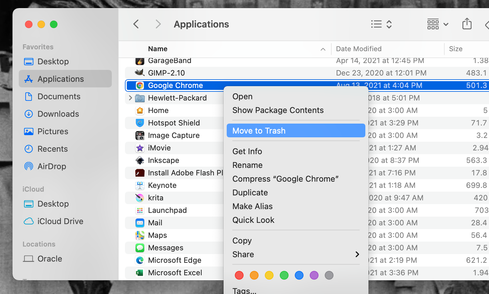 The Google Chrome application being moved to Trash within a MacBook Pro's Applications folder