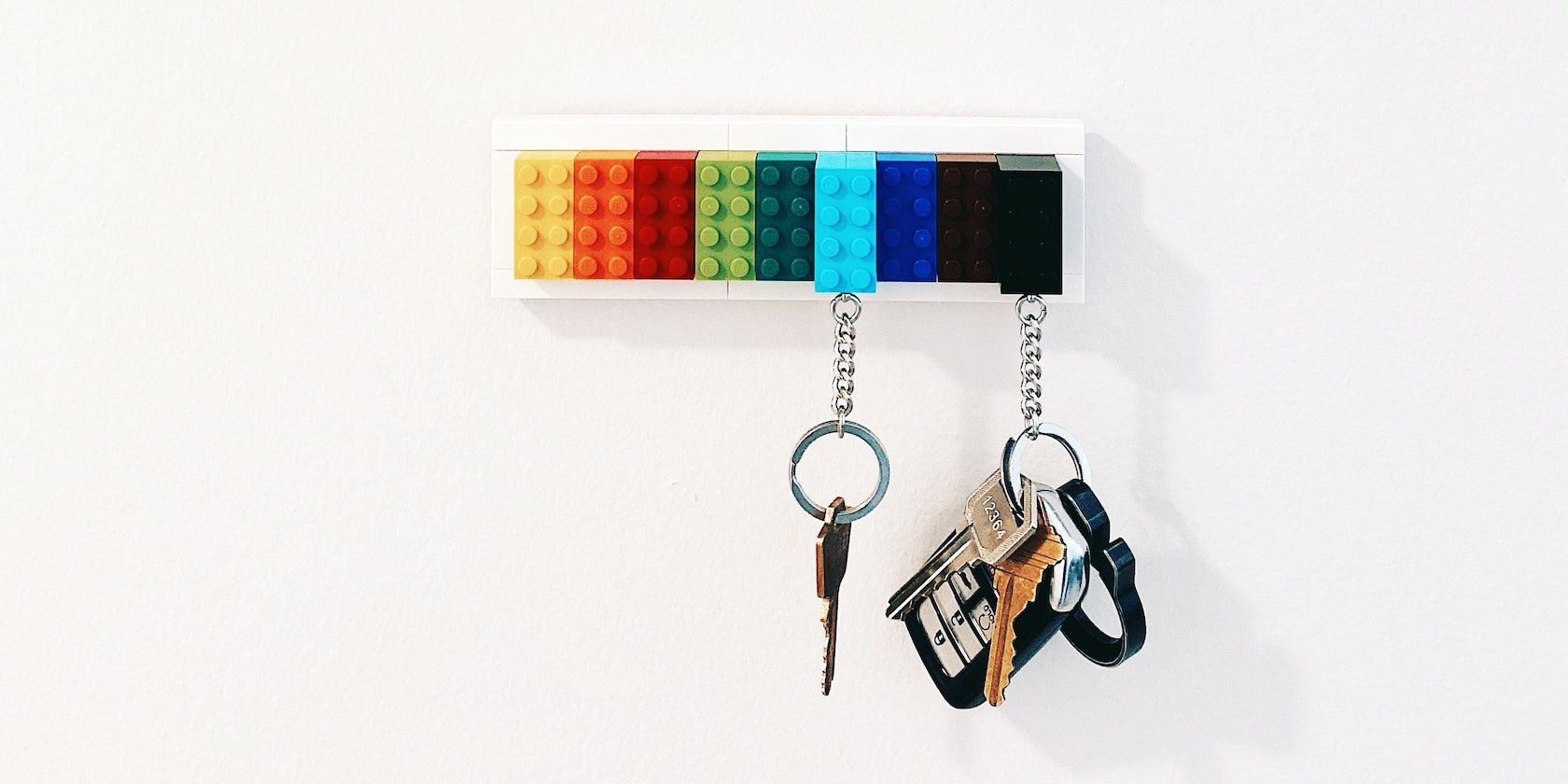 Keychains with keys on them hang on a wall