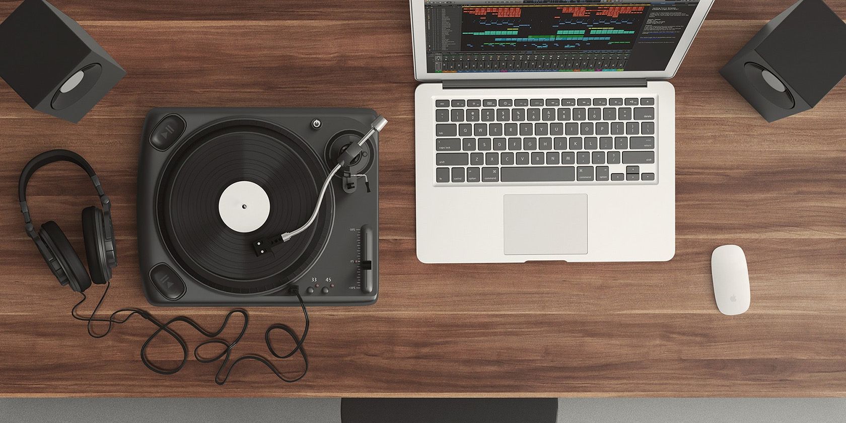 MacBook next to a record player.