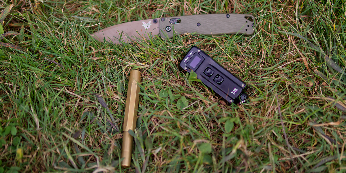 T4K with knife and brass pen in grass