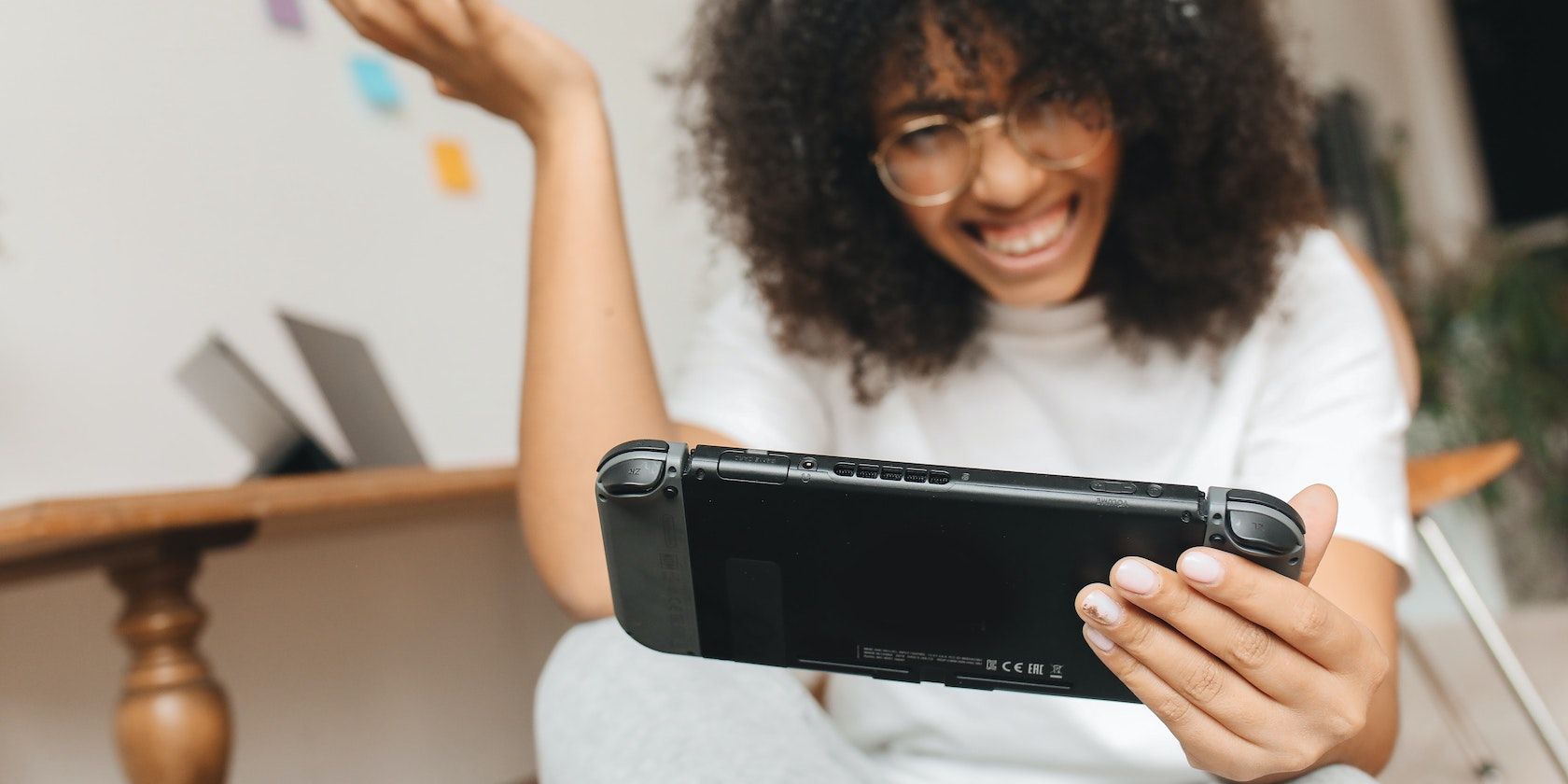 Woman holding Nintendo Switch featured image