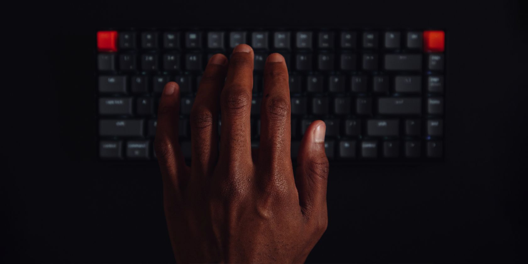 a hand hovering on a keyboard