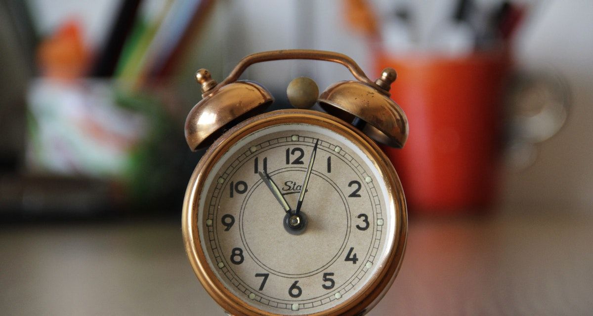 Antique alarm clock on table