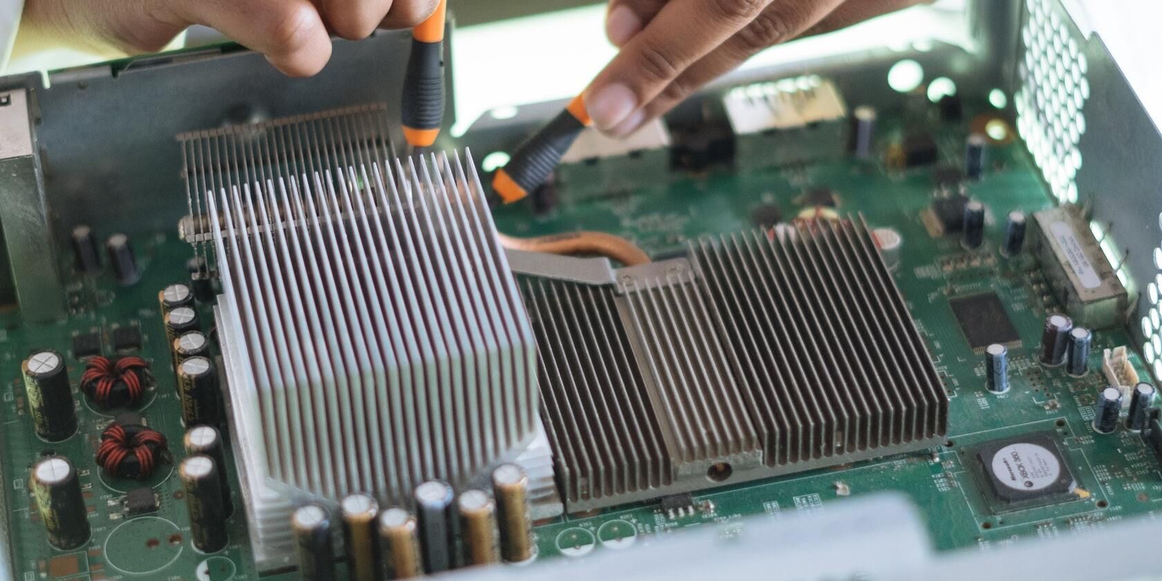 Person tampering with a motherboard.
