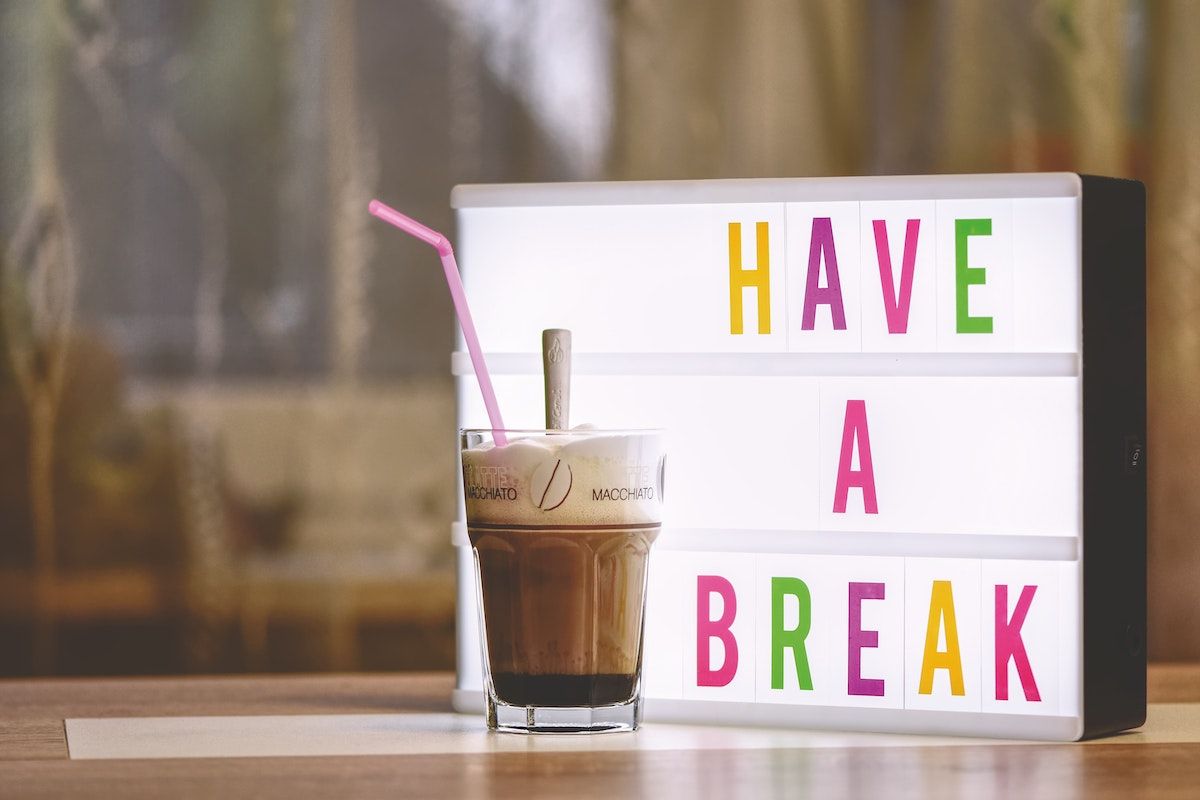 coffee cup in front of have a break sign