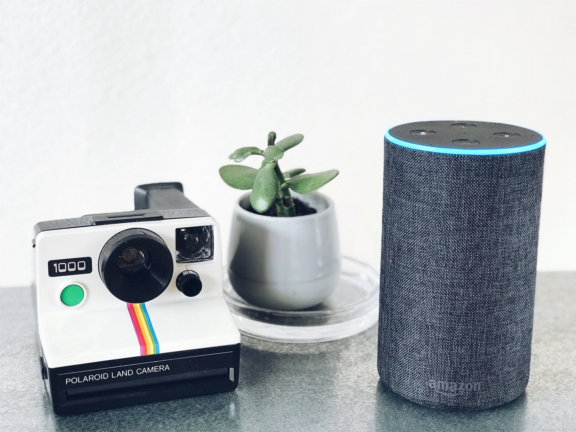 An Amazon Echo besides a camera