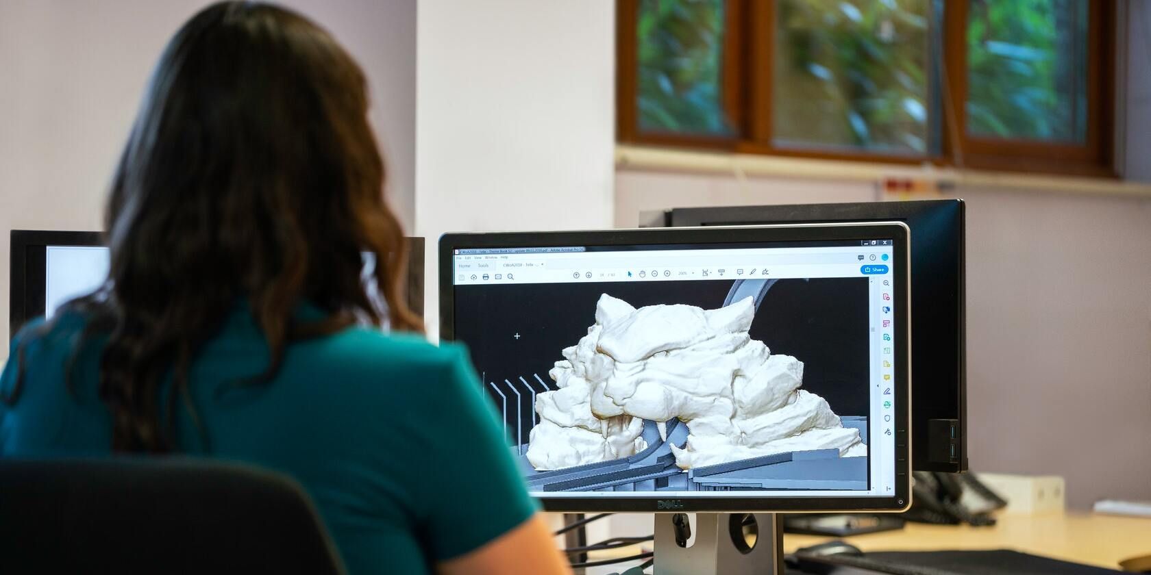 Person using a 3D design software on a computer.