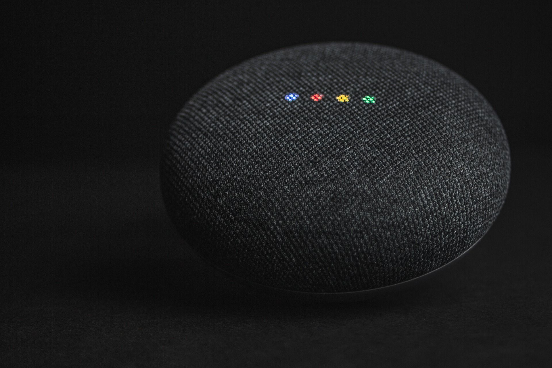 Black Google home speaker on black background