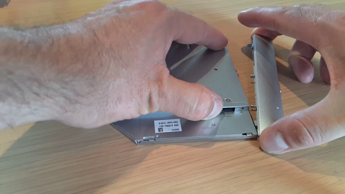 Remove the fascia or bezel from a DVD drive