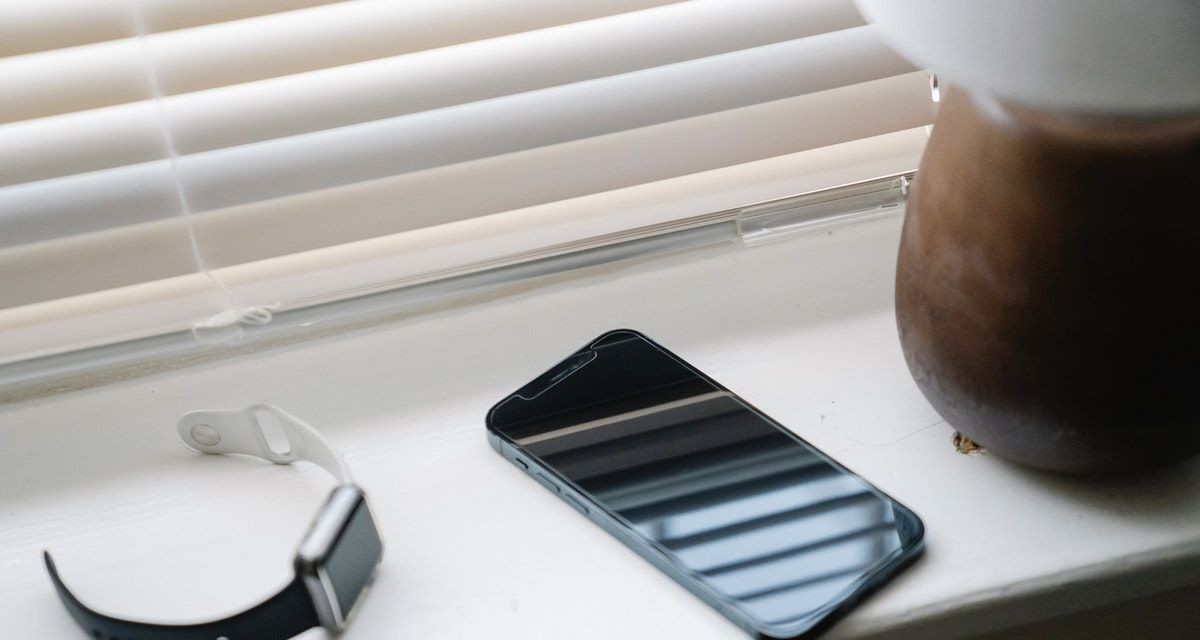 Phone and smart watch on window sill