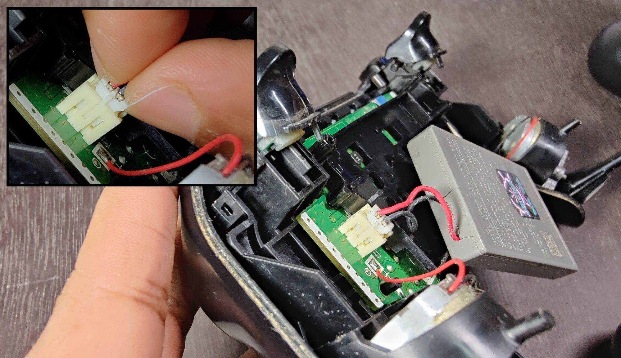 Removing the battery terminal of the PS4 controller.