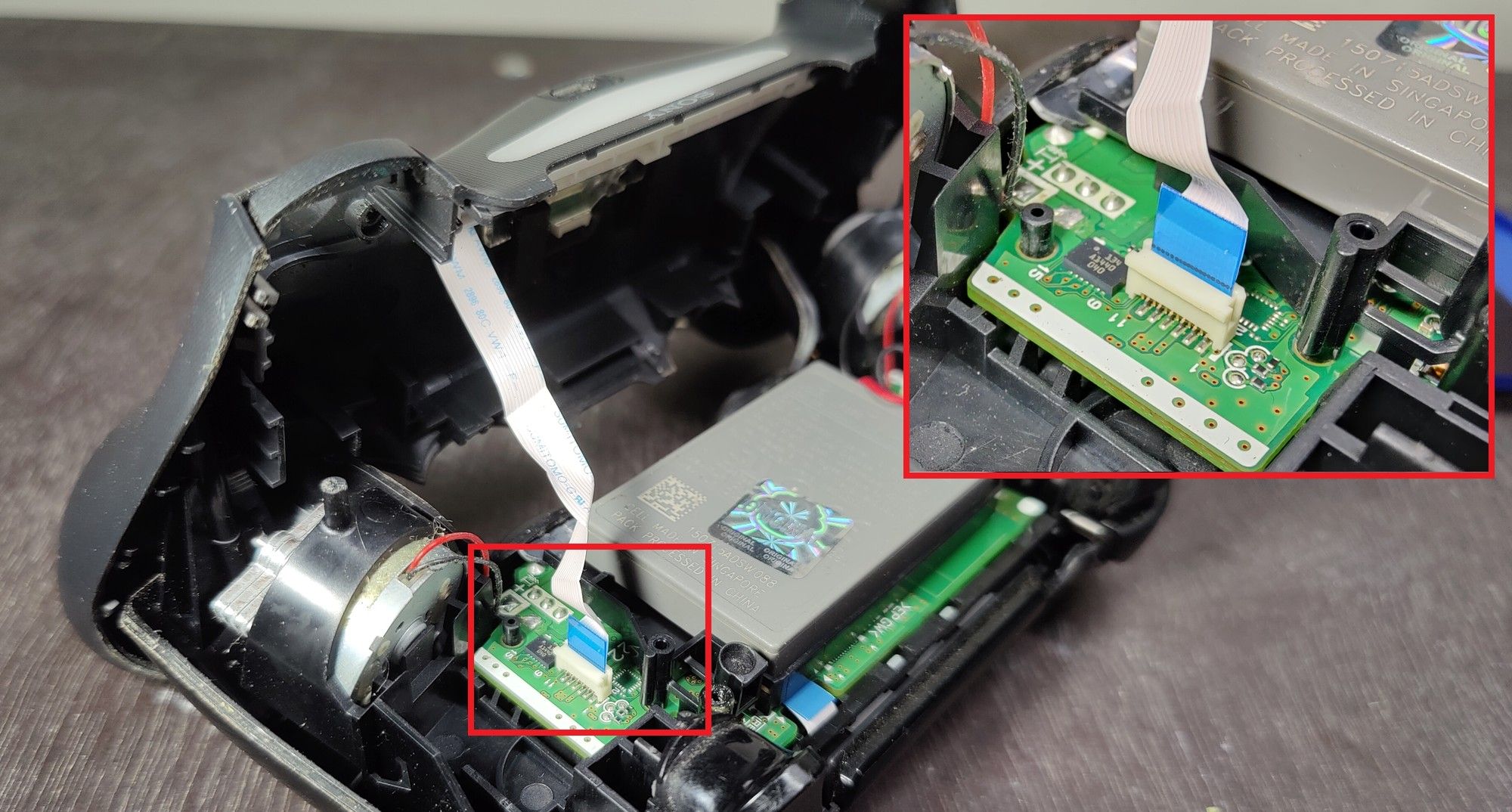 Removing PS4 controller's ribbon cable.