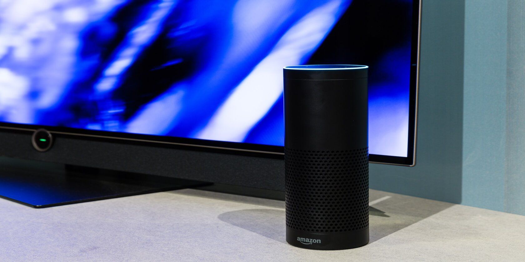 Amazon echo speaker beside a TV