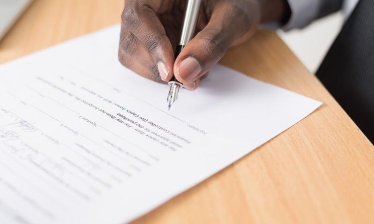 hand signing papers with landlord