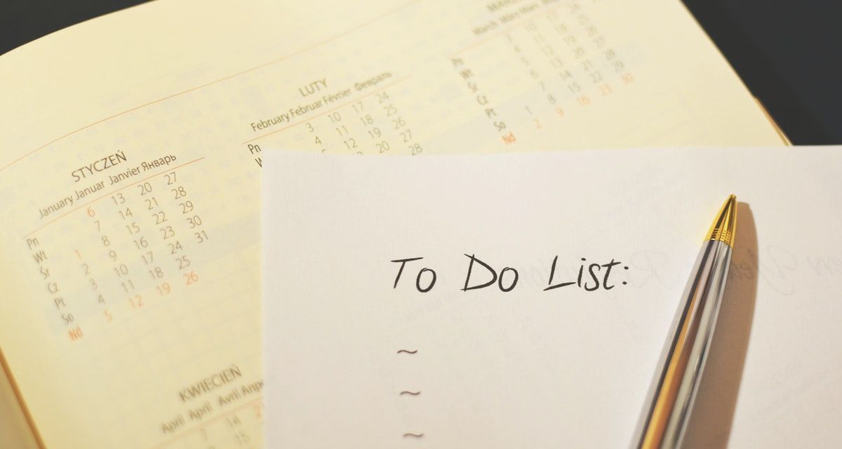 Paper with to-do list on top of calendar