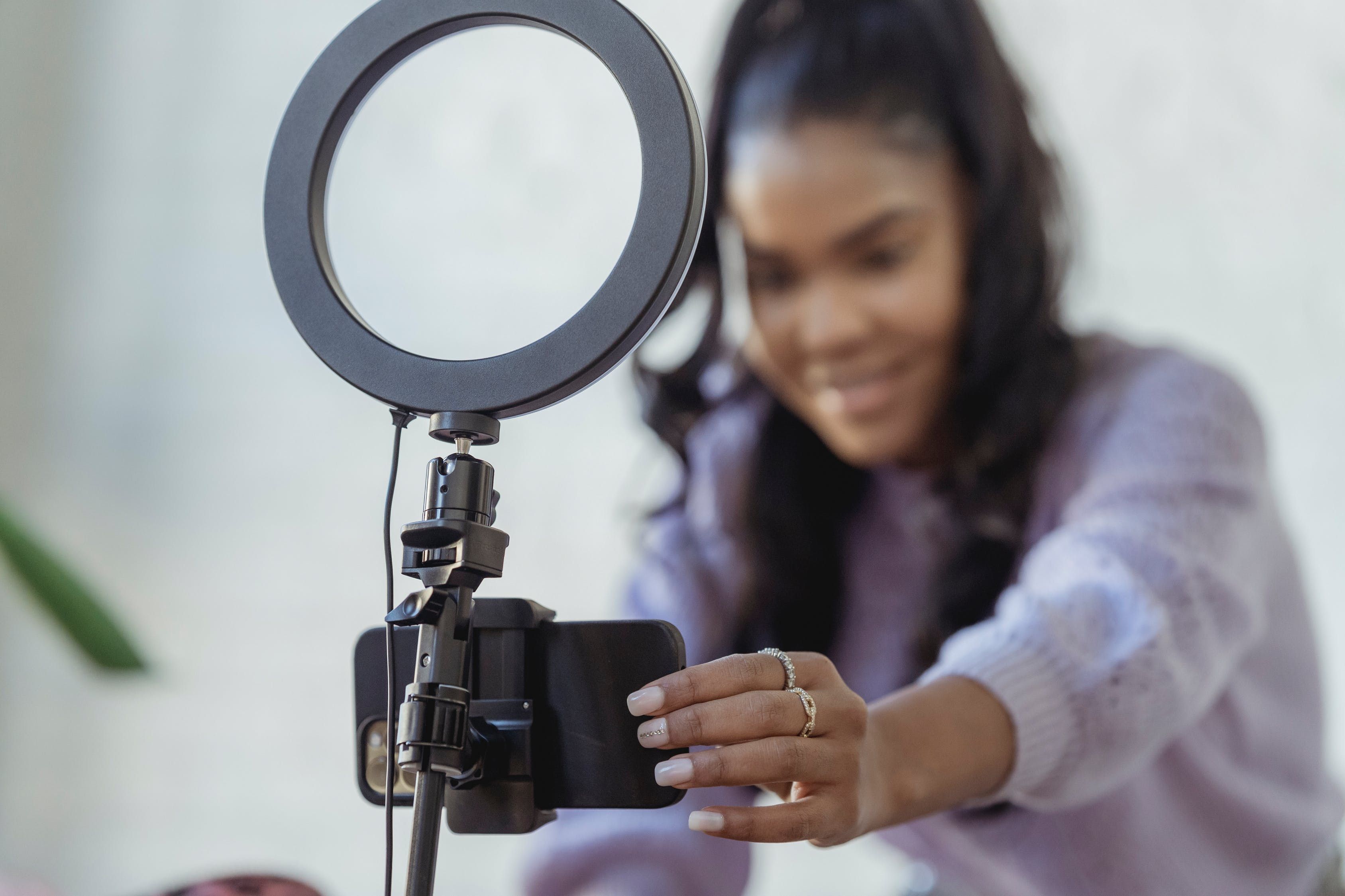 Woman Adjusting Camera Phone