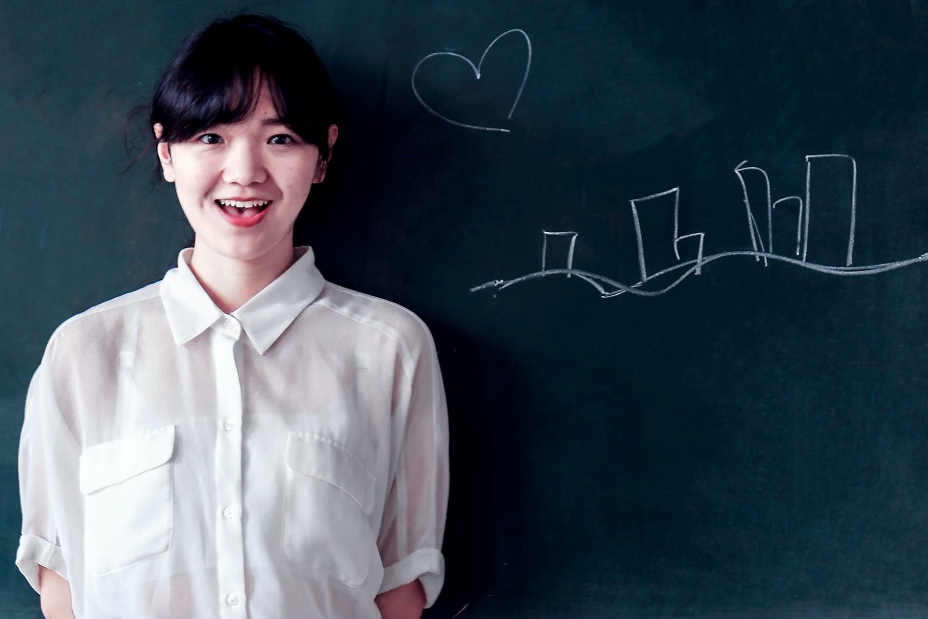 Woman Standing in Front of Chalkboard