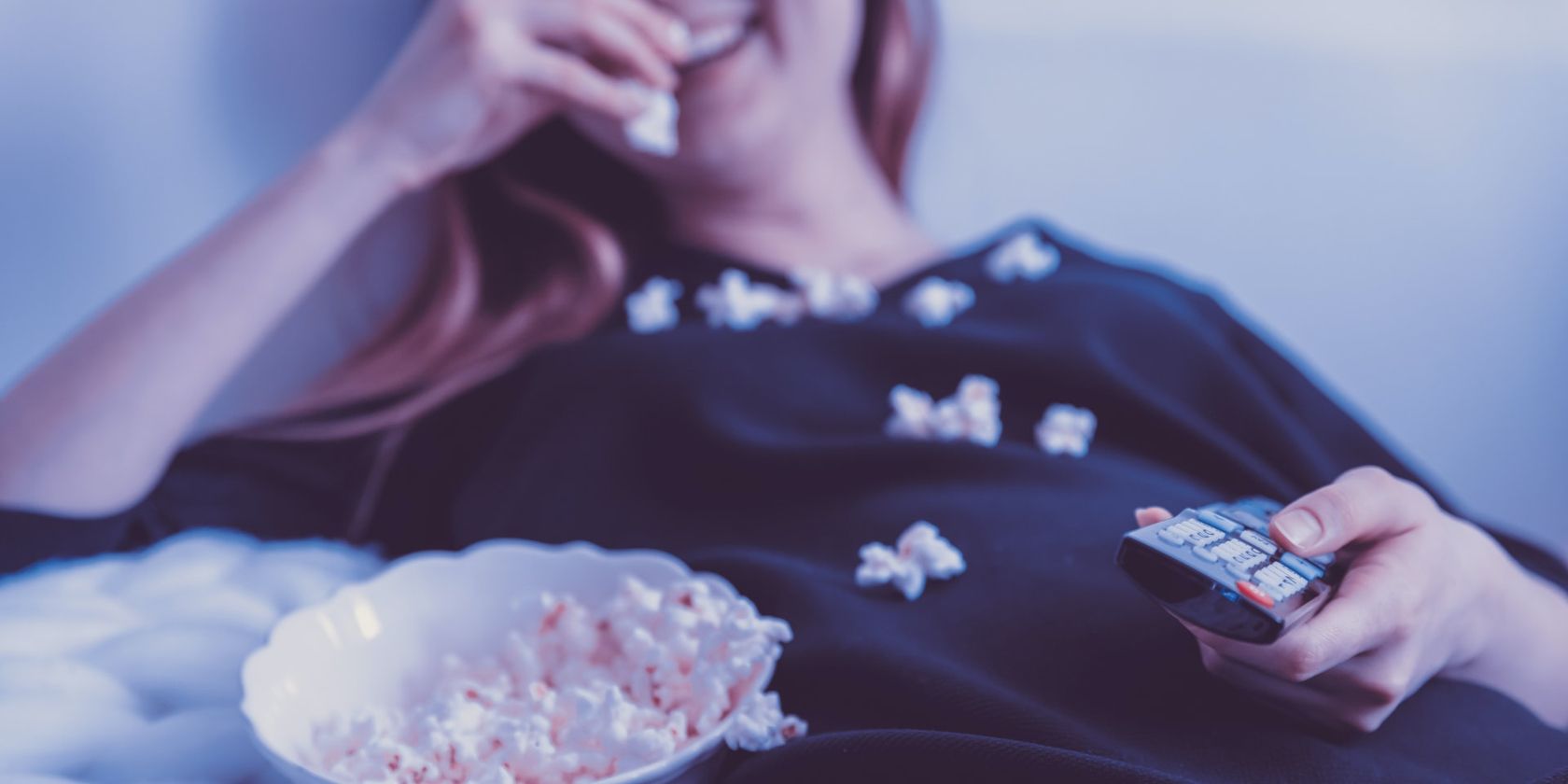 Woman Watching TV and Eating Popcorn