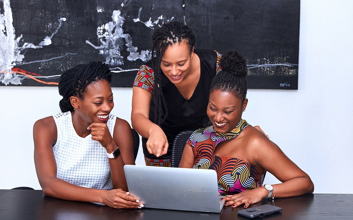 A group of women laughing at work