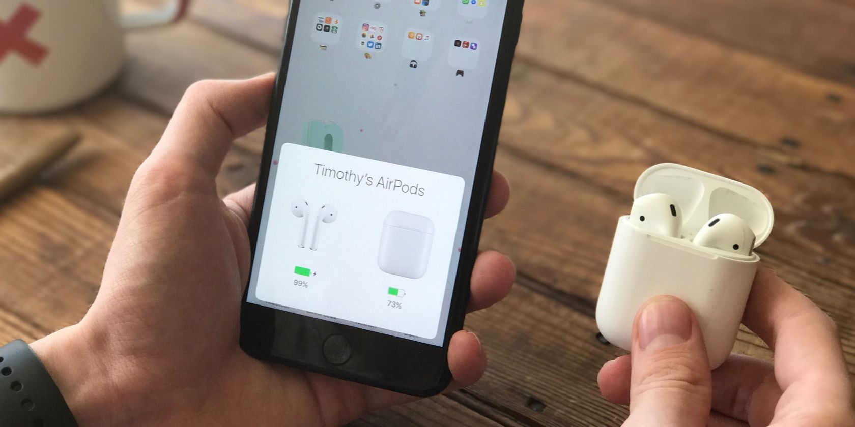 Photo of a person looking at their AirPods' charging status