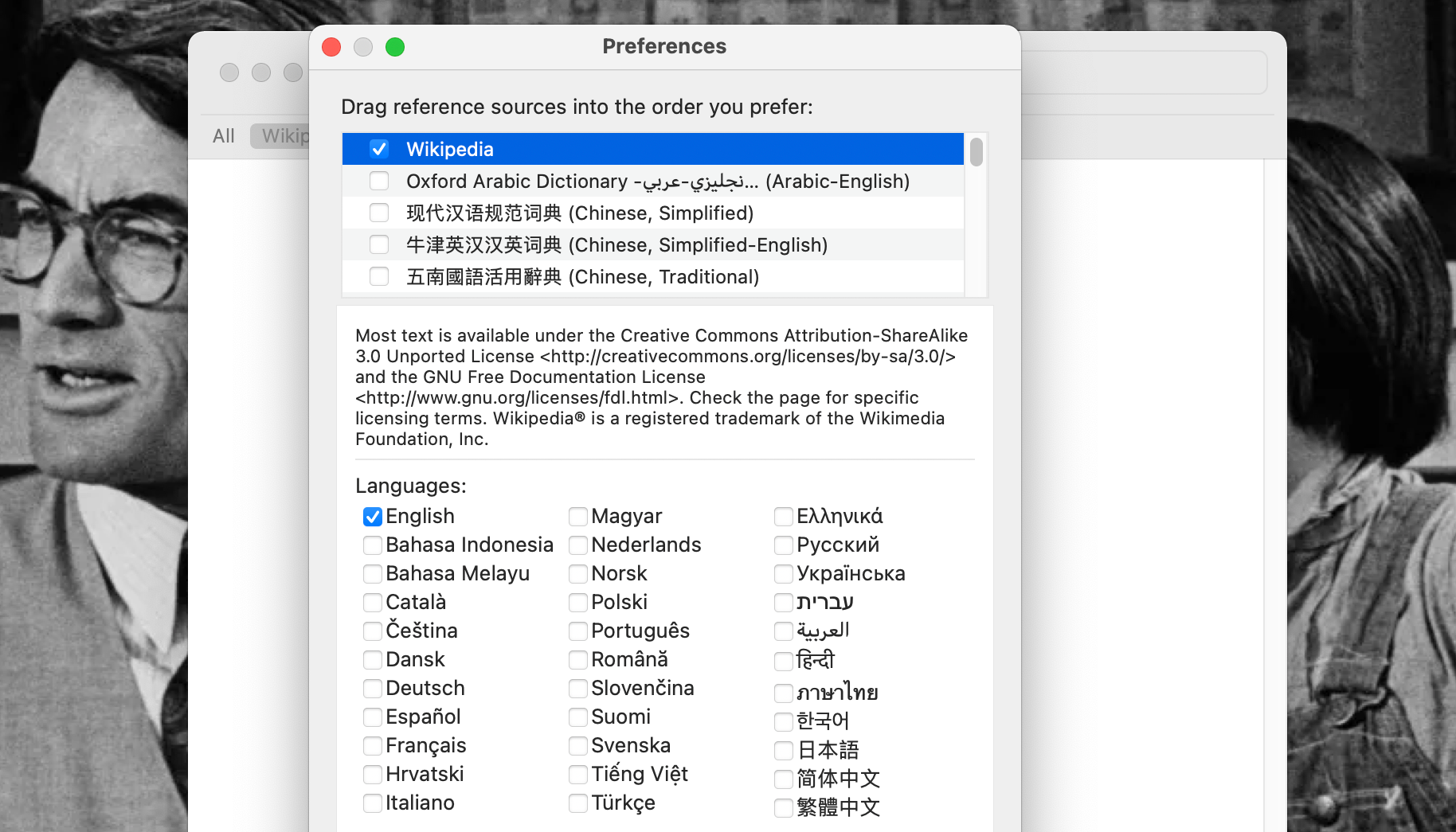 Dictionary's Preferences open with Wikipedia selected and its language options listed on a MacBook Pro