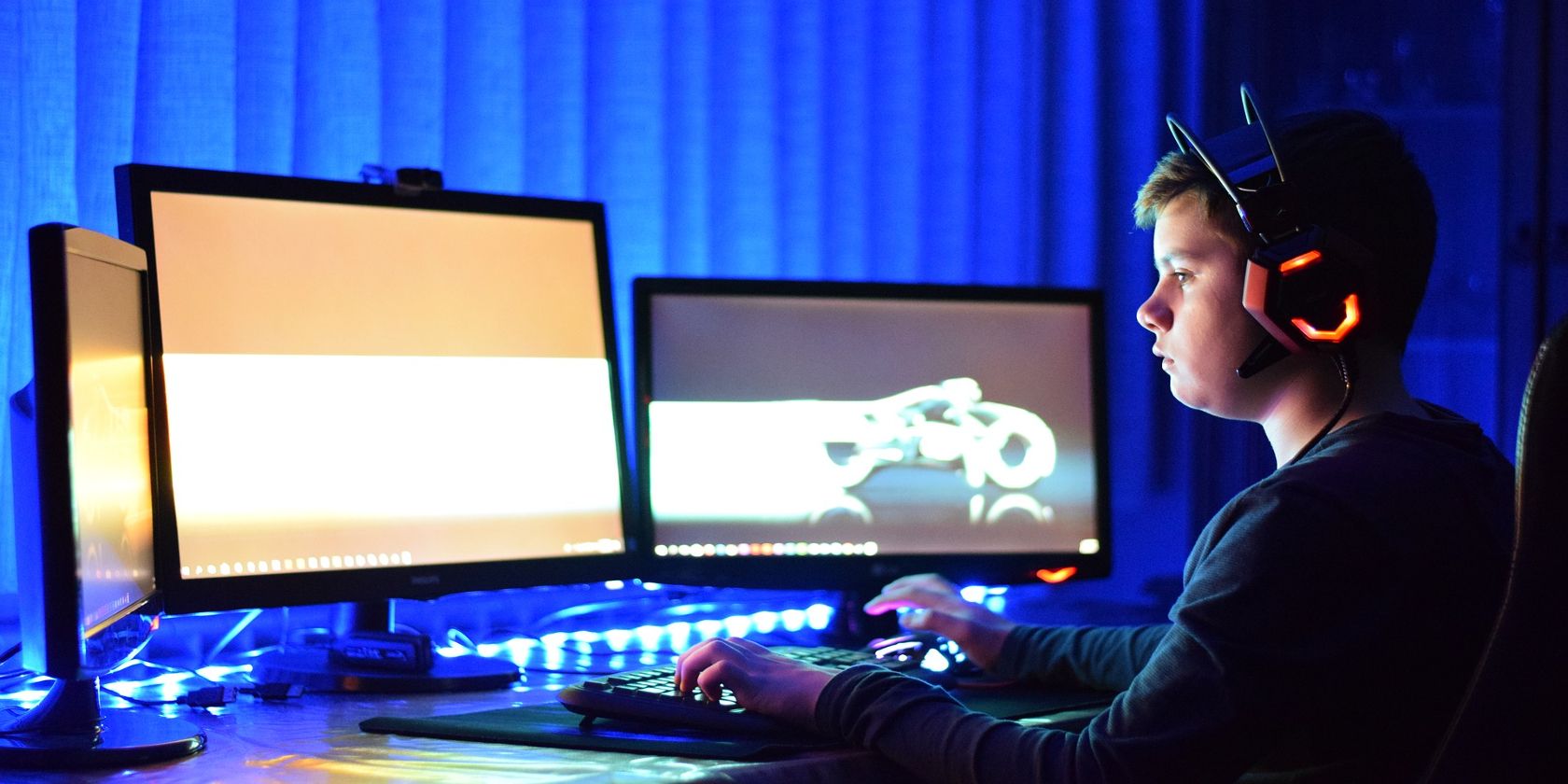 Kid at Computer Monitors with blue background