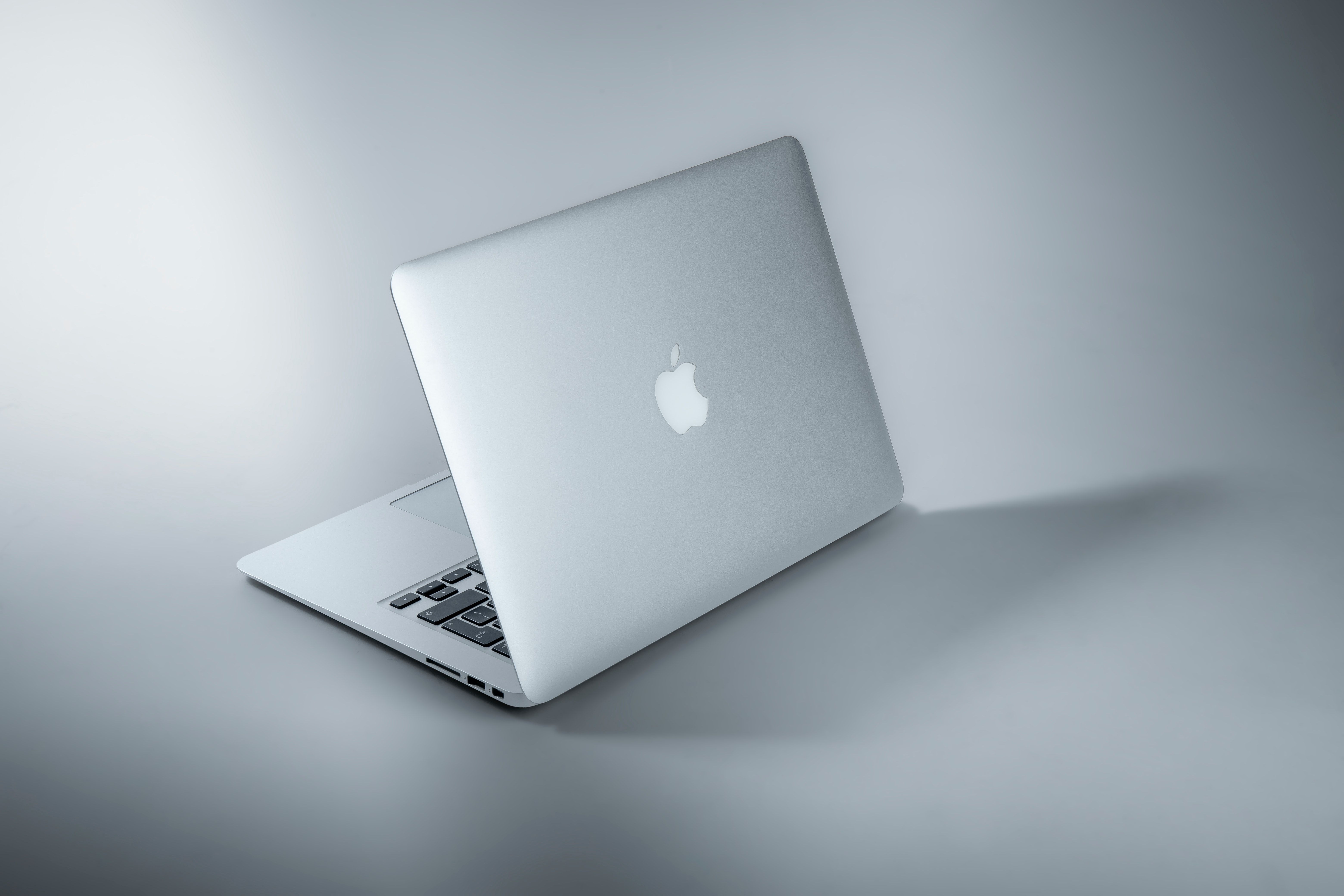 Photo of a MacBook With a Grey Background