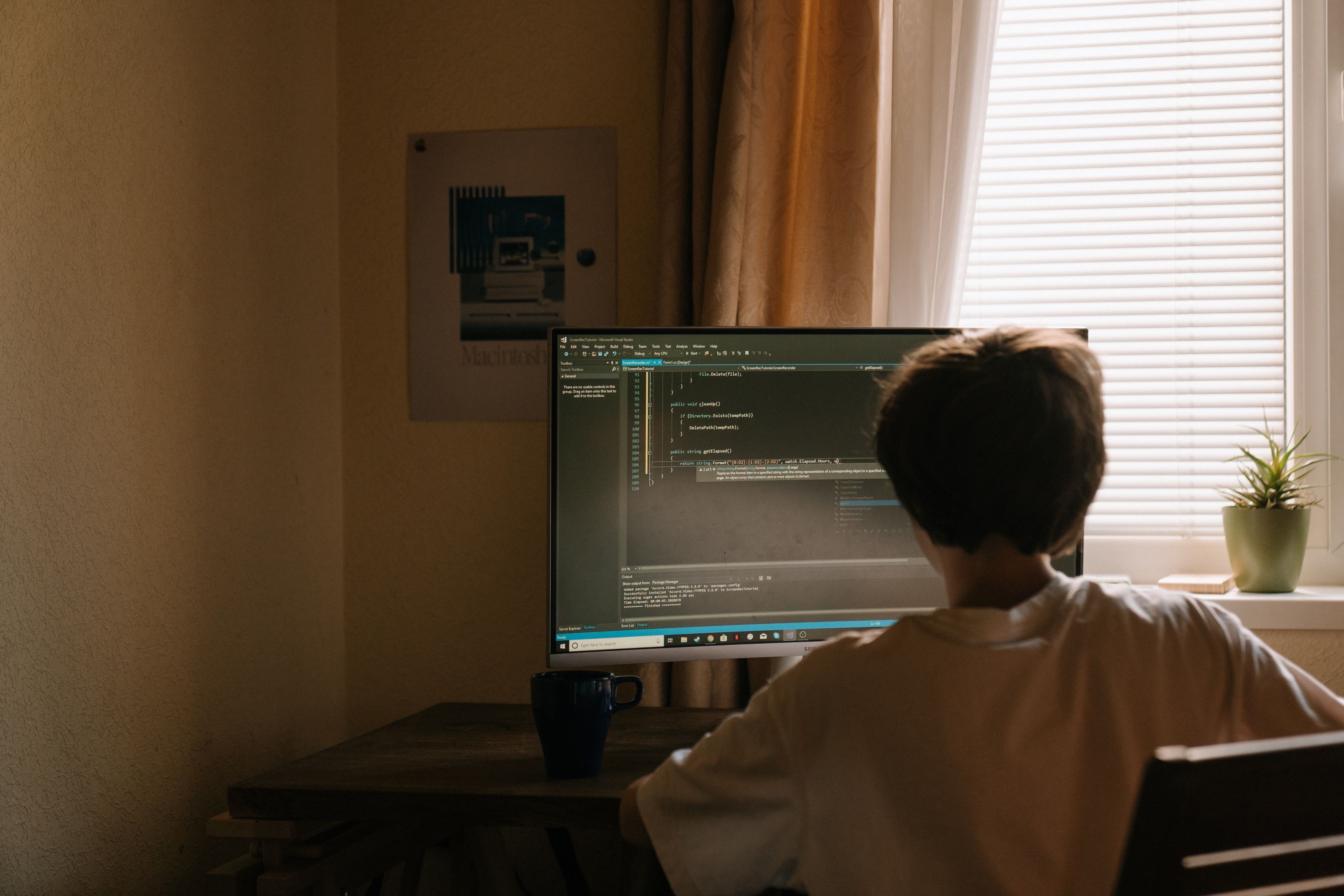 Photo of a person sitting at their computer indoors