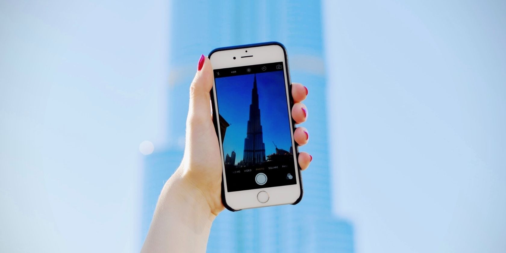 Person taking a photo of a landmark using an iPhone
