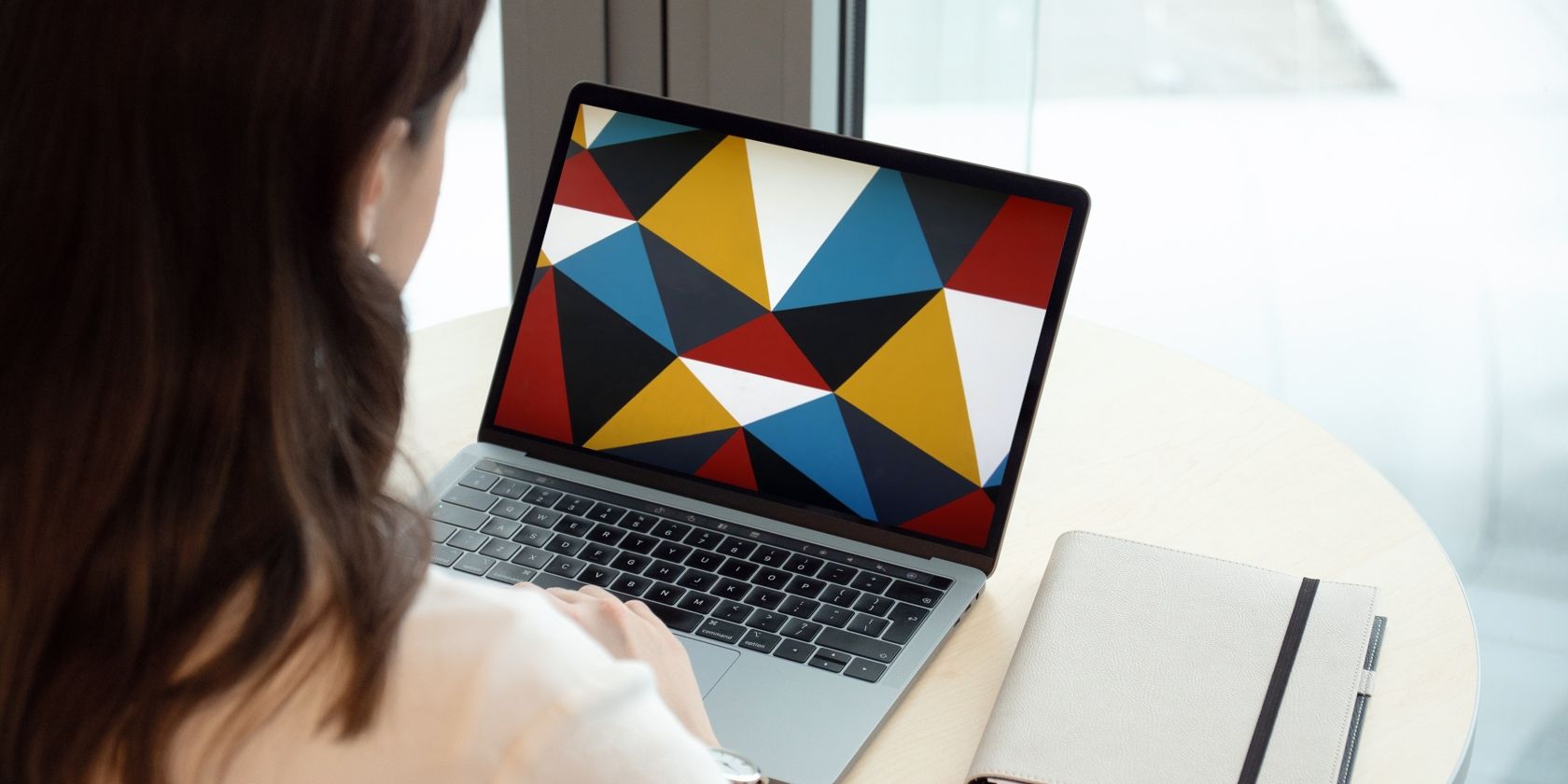 Woman looking at patterned background on laptop
