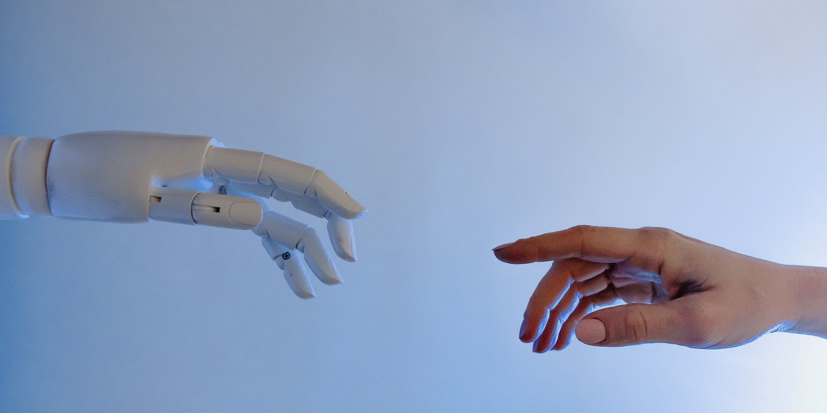human and robot hand coming together