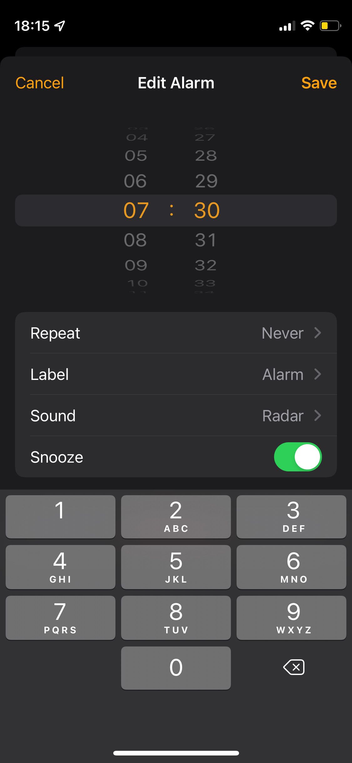 iPhone Alarm app showing keyboard for times