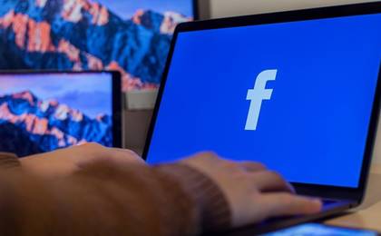 laptop with facebook icon on screen