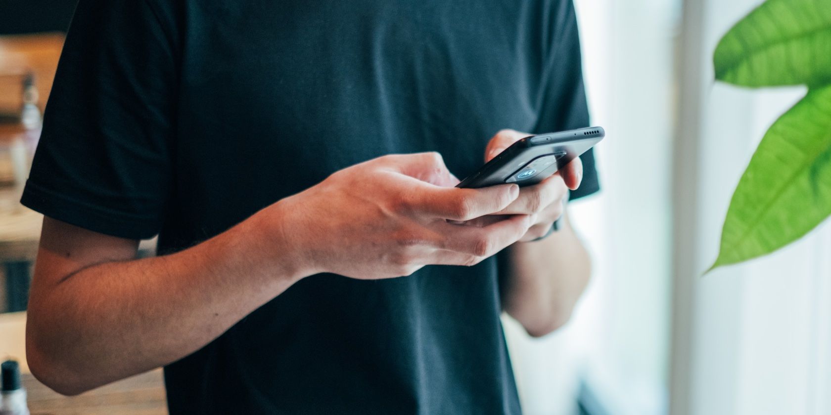 man typing on phone