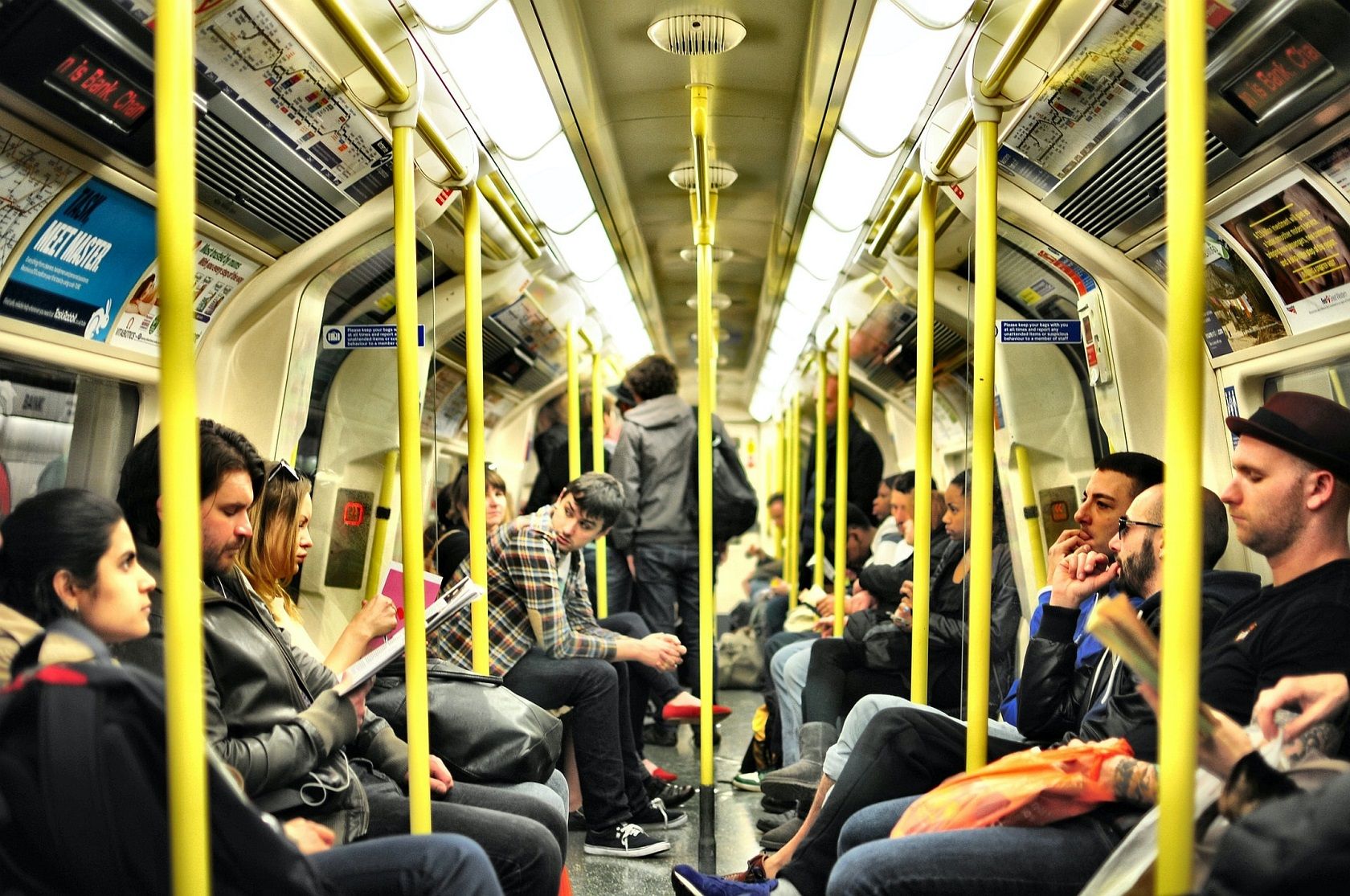 many-people-on-metro-with-yellow-poles