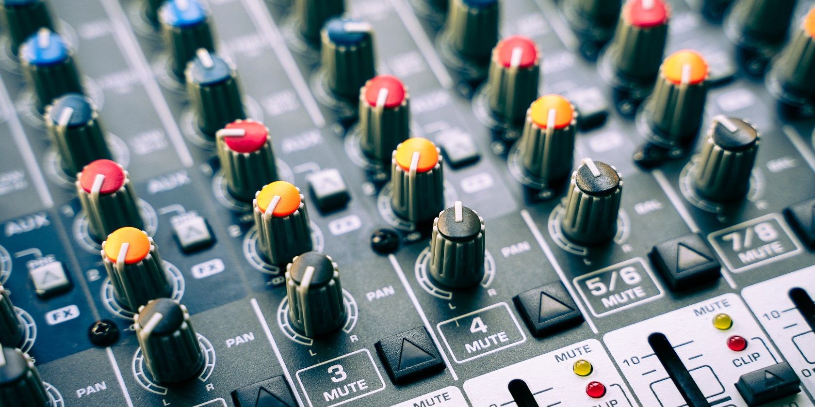 gray sound mixer board with colorful knobs