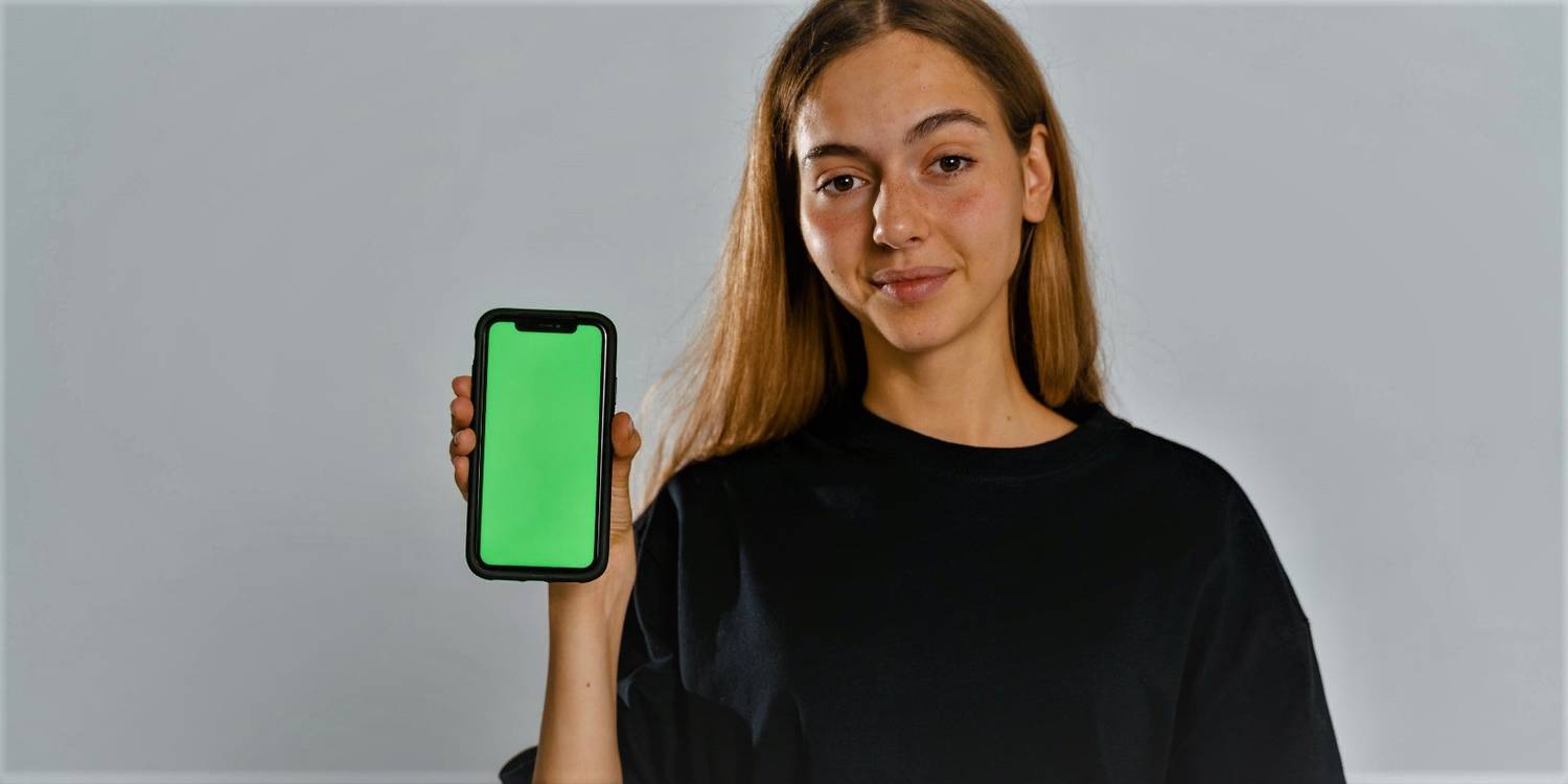 Person Holding Phone With Green Screen