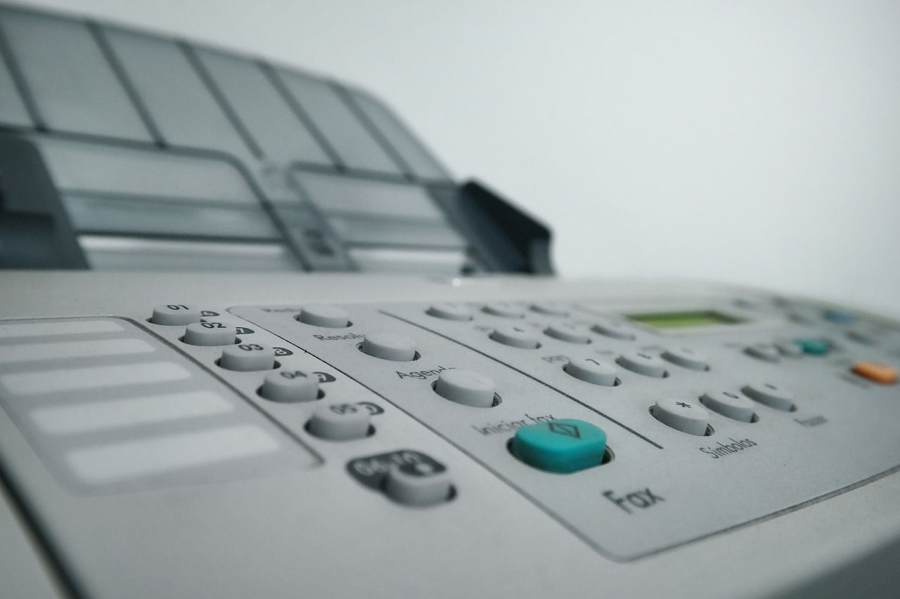 Image shows a close-up of a fax machine