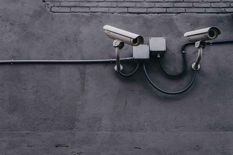 two-wired-security-cameras-on-wall