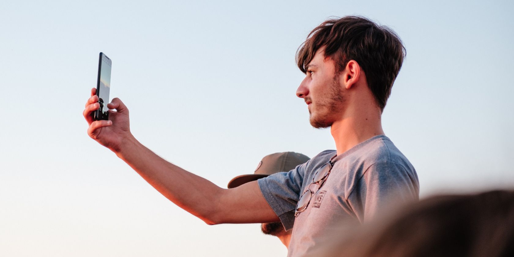 Photo of a person taking a picture around sunset