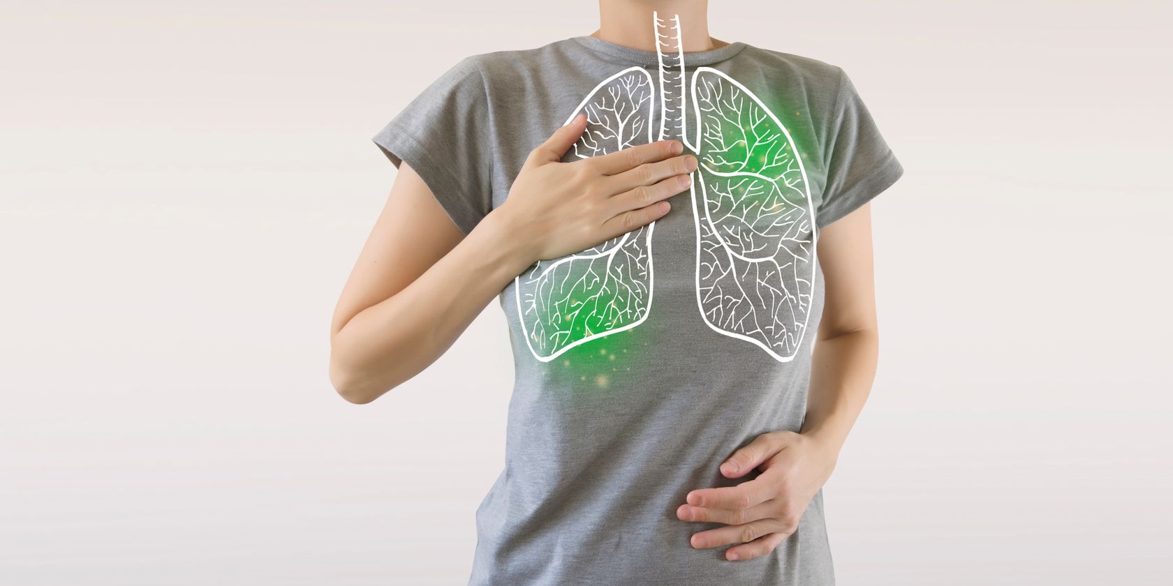 Woman with lungs superimposed on body touching chest