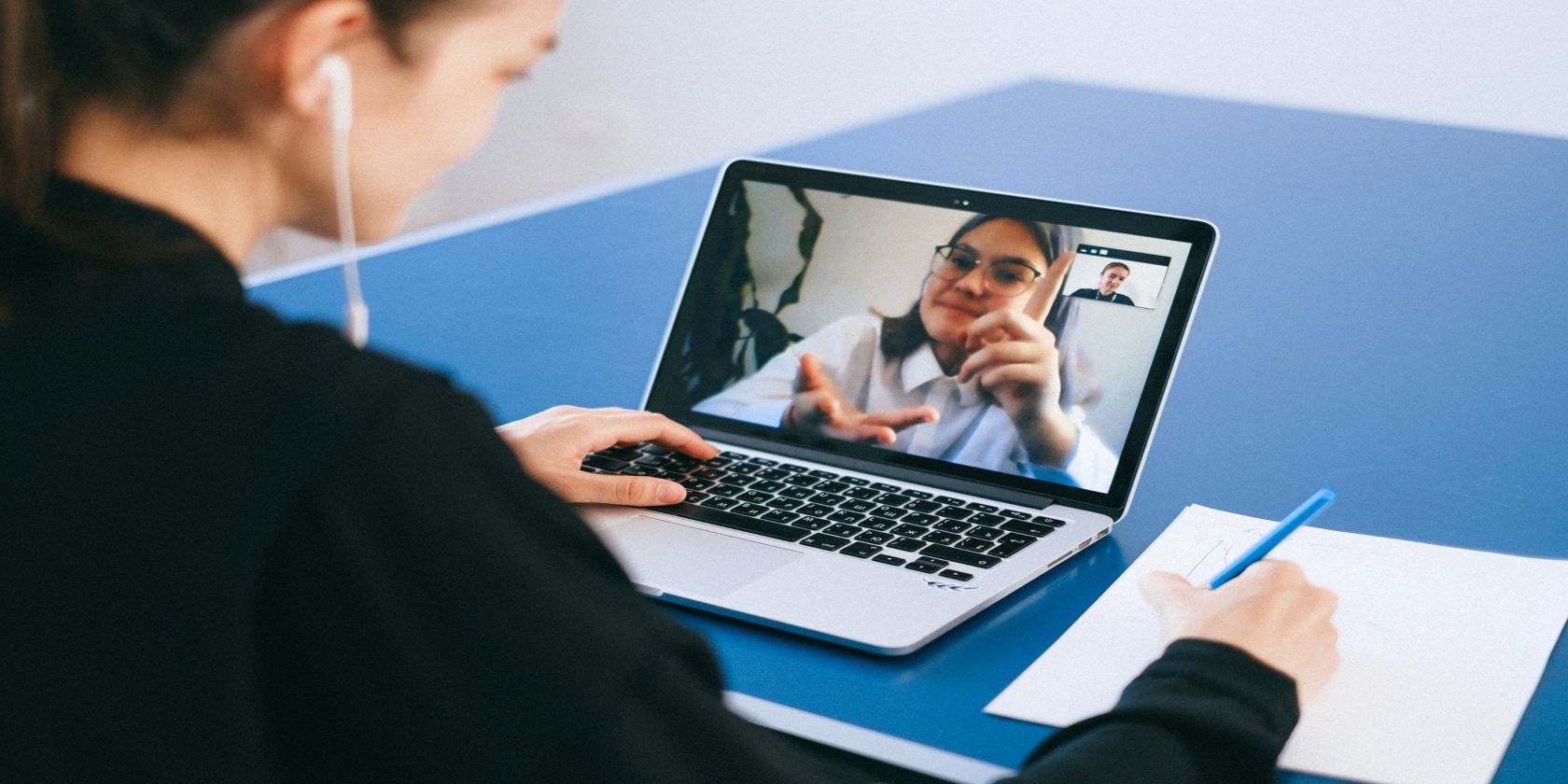 A women using Zoom for a video call on a Mac laptop