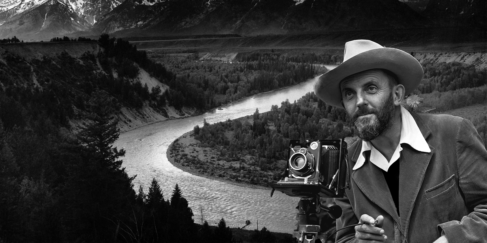 Ansel Adams in front of a photo of his.