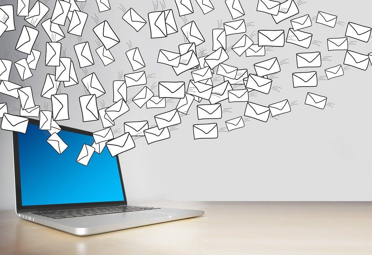 Photograph of Laptop with Envelopes Floating Out of Screen